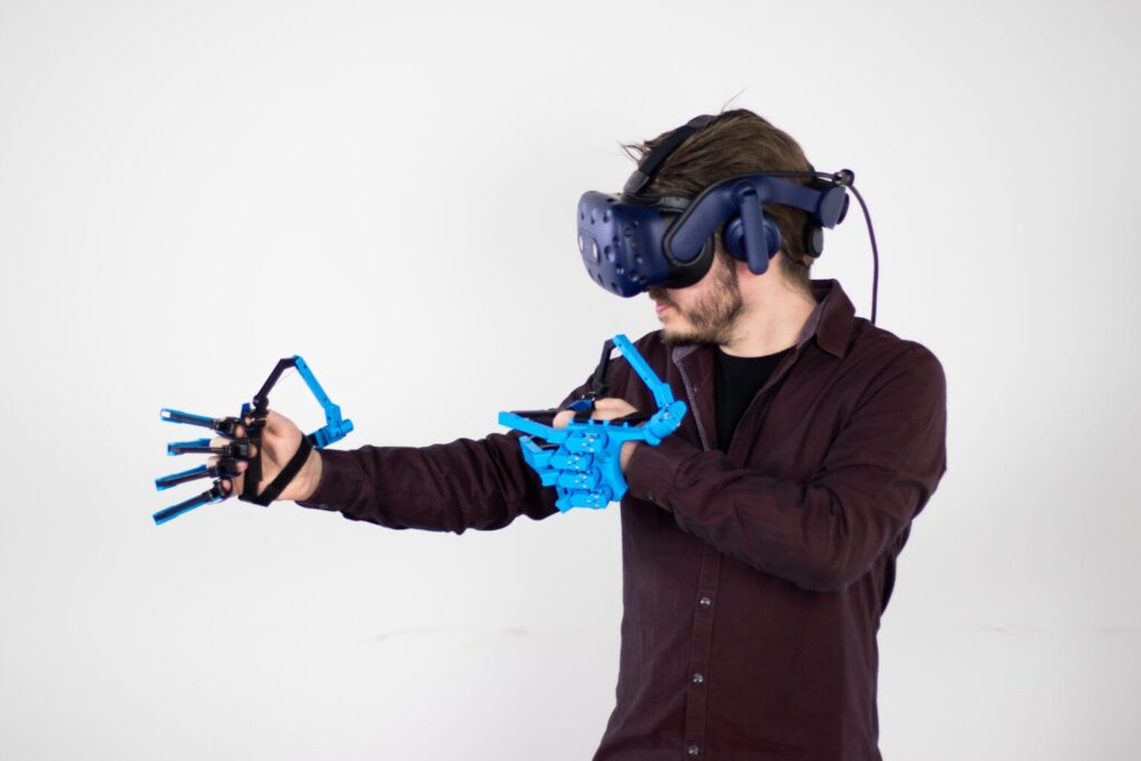 man met 2 sensegloves en een vr-bril